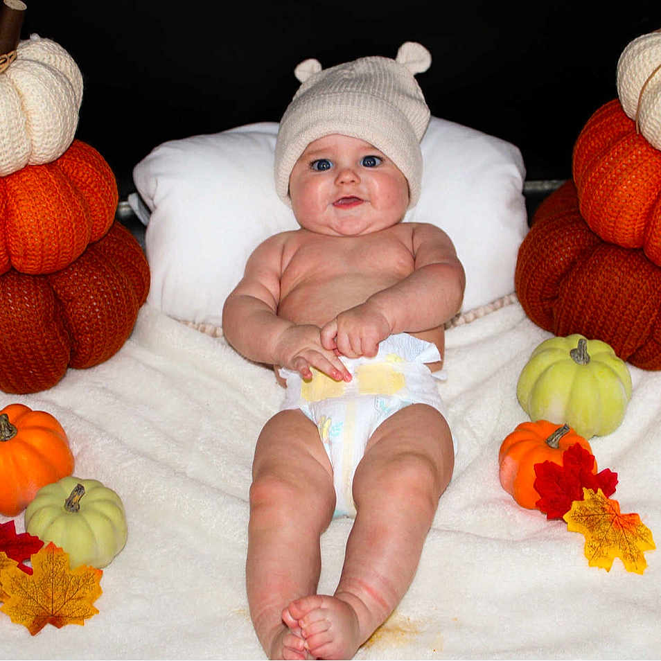 Liam joined the competition — help win amazing prizes! baby, infant, diaper, knit_hat, blanket, pumpkin, knitted_pumpkin, autumn_leaves, fall, cute, chubby, blue_eyes, smiling, lying_down, cozy, soft_texture, child, seasonal, holiday, cute_hat