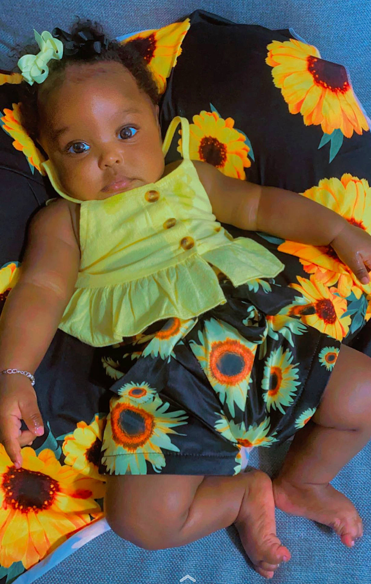 Kamari is registered to the contest to win money with this photo: baby_toddler_clothing, blue, dress, eye, face, flower, green, hair, hairstyle, happy, head, human_body, leg, orange, organ, person, plant, skin, sleeve, textile