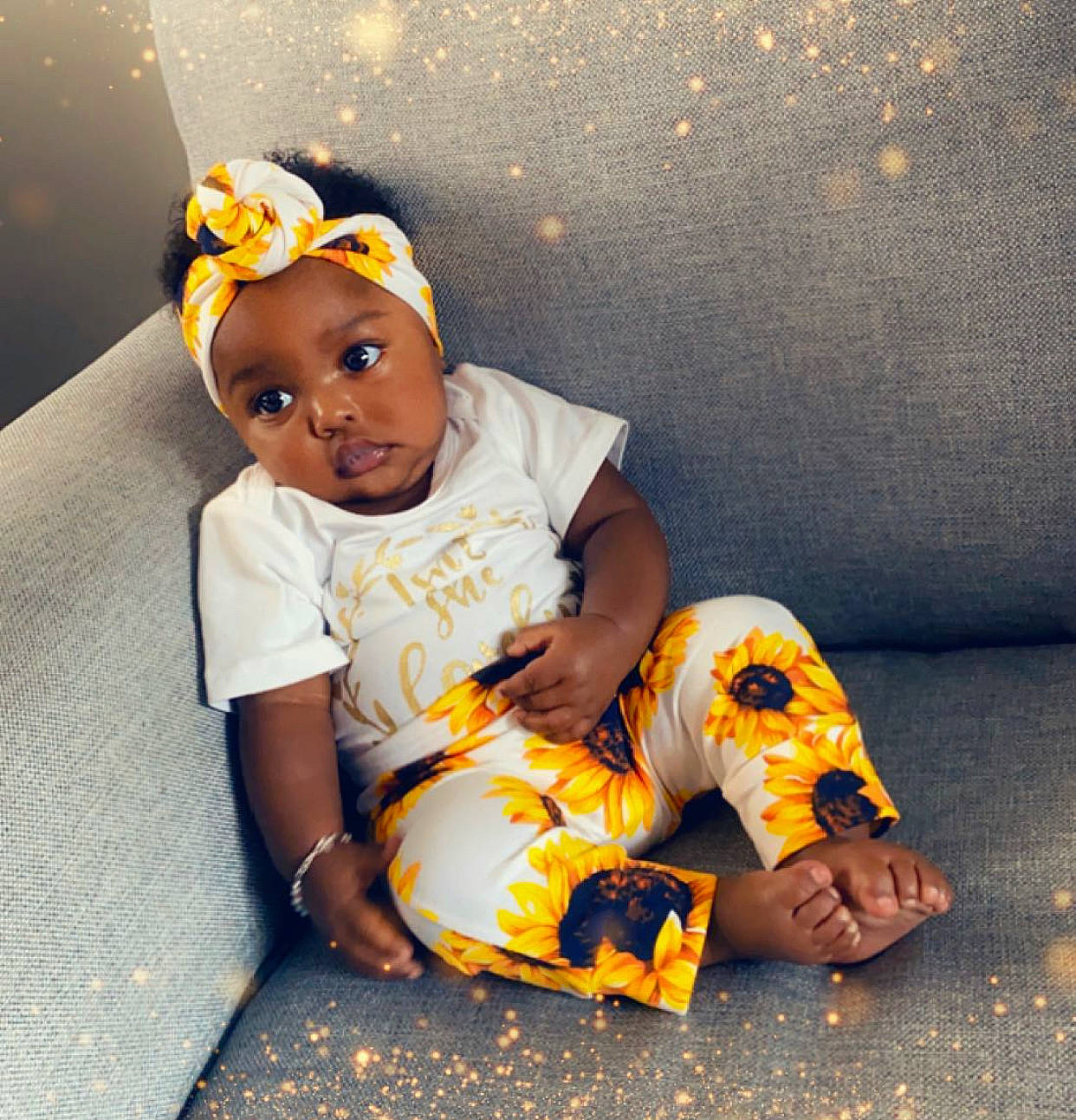 Kamari joined the competition — help win amazing prizes! baby, baby_toddler_clothing, cap, child, comfort, costume_hat, fashion_accessory, flooring, foot, fun, happy, headband, human_leg, leisure, orange, person, sitting, sleeve, t_shirt, thigh
