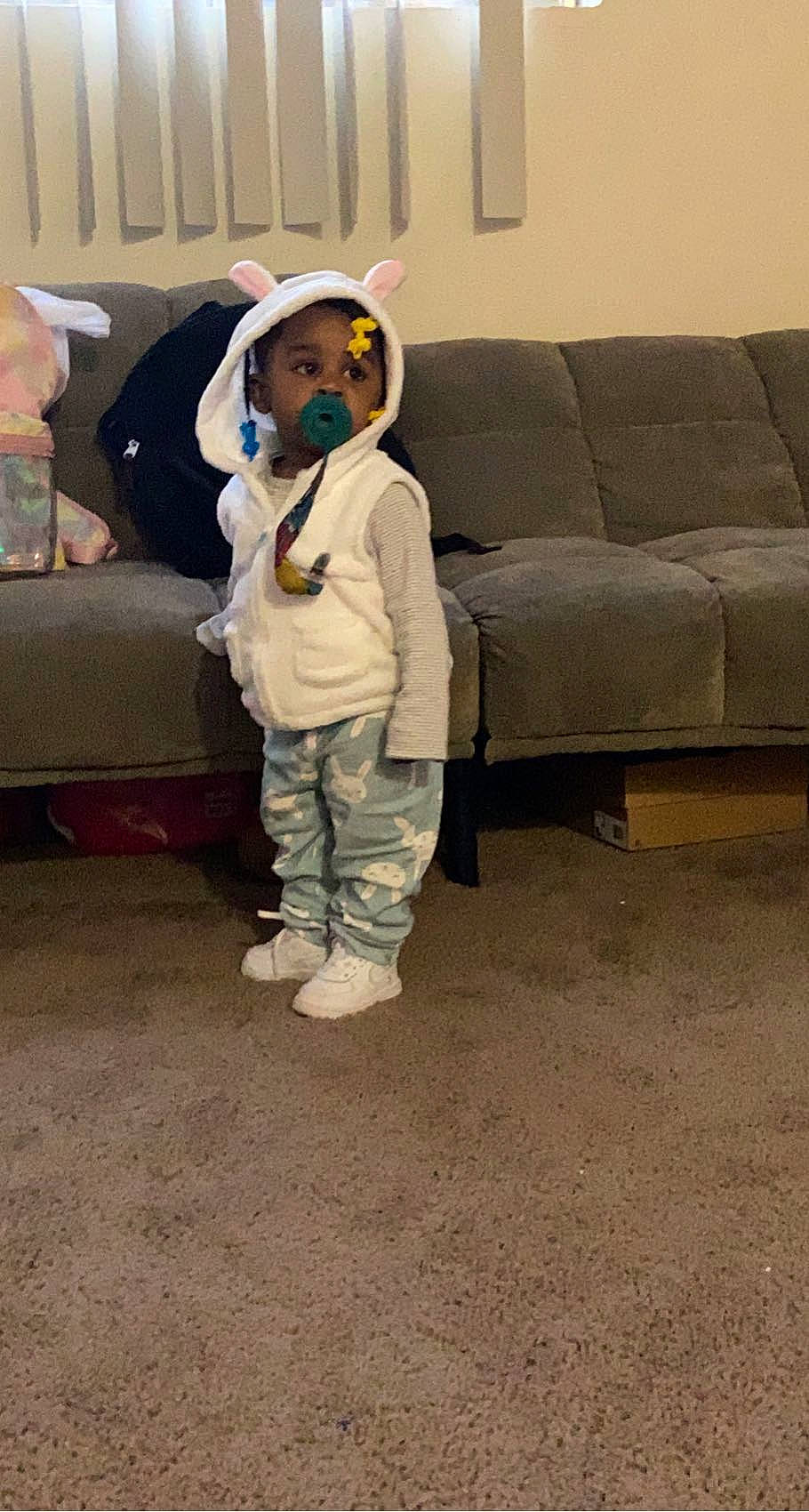 Devonna is registered to the contest to win money with this photo: child, comfort, couch, floor, flooring, fur, furniture, hardwood, linens, living_room, person, pillow, room, sitting, slipcover, sofa_bed, studio_couch, stuffed_toy, throw_pillow, toddler