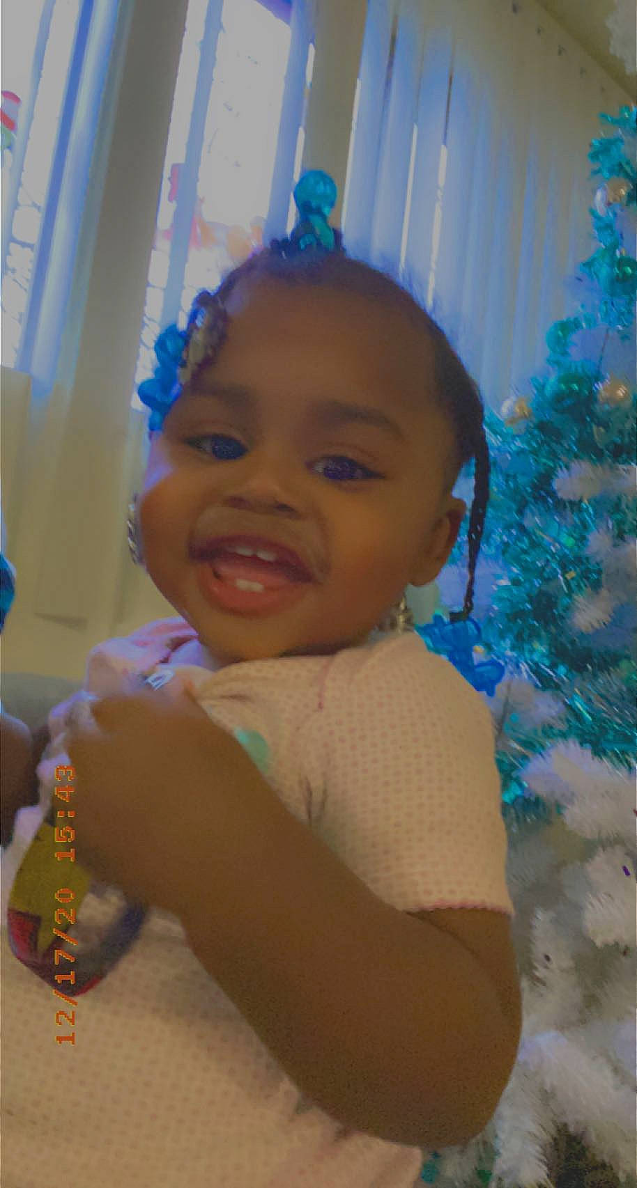 Devonna is registered to the contest to win money with this photo: baby, blue, child, christmas_decoration, christmas_tree, curtain, electric_blue, event, fun, hairstyle, happy, holiday, holiday_ornament, leisure, mouth, ornament, person, room, smile, toddler
