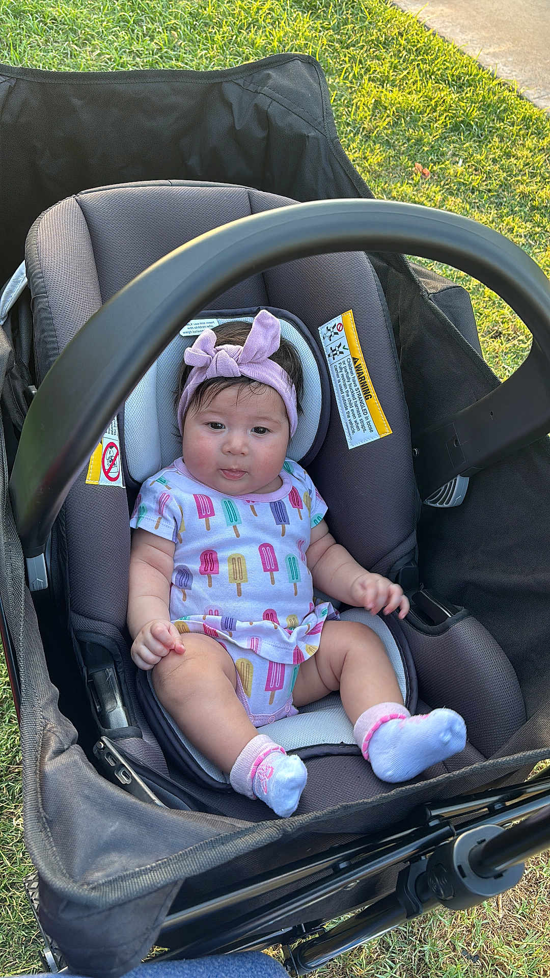 Bealhy is registered to the contest to win money with this photo: baby, stroller, headband, onesie, socks, grass, outdoor, child, infant, seat, sunlight, tongue, cute, colorful, popsicle_pattern, fabric, playful, summer, park, happy