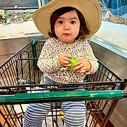 Paulette joined the competition — help win amazing prizes! toddler, child, shopping_cart, hat, grocery_store, seafood, container, clothing, striped_pants, sneakers, indoor, person, retail, aisle, holding, face, eyes, cute, curious, shopping