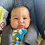 baby, beads, car_seat, child, closeup, clothing, cute, expression, face, hair, head, indoor, infant, pacifier, person, portrait, pout, safety, seatbelt, skin