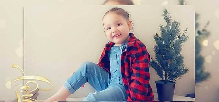 Tatianna is registered to the contest to win money with this photo: baby, baby_toddler_clothing, child, conifer, electric_blue, facial_expression, flowerpot, fun, happy, houseplant, jacket, joy, neck, pattern, person, plaid, plant, sitting, sleeve, smile