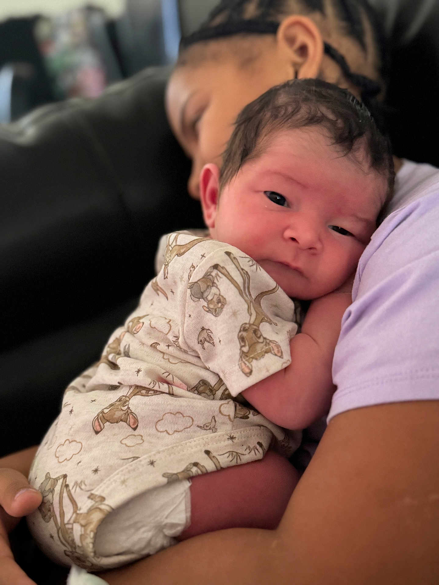 Nasir joined the competition — help win amazing prizes! adult, animal_print, baby, blurred_background, closeup, couch, cozy, diaper, face, family, holding, indoor, infant, love, newborn, onesie, portrait, snuggling, soft_lighting, tenderness