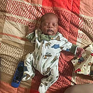 Kyran joined the competition — help win amazing prizes! baby, sleeping, onesie, blanket, remote_control, pillow, teddy_bear_pattern, bedroom, infant, cozy, patterned, child, peaceful, cute, resting, home, soft, fabric, person, relaxing