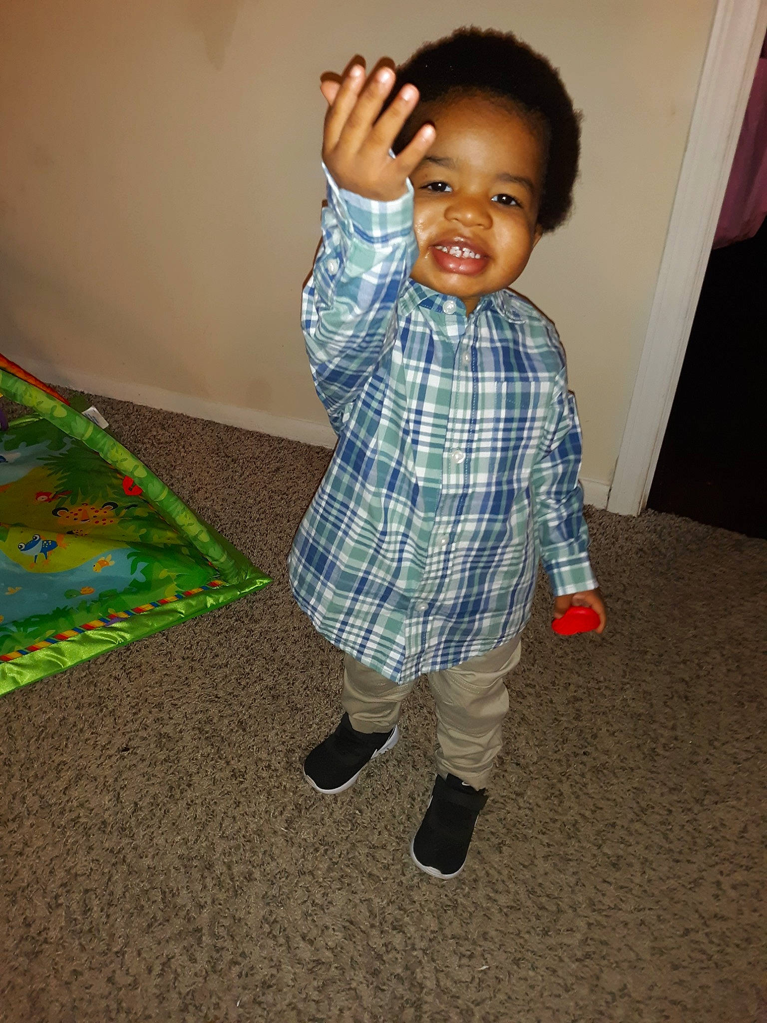 Devin Jr is registered to the contest to win money with this photo: baby, cheek, child, floor, flooring, joy, outerwear, pattern, person, plaid, play, skin, smile, standing, toddler