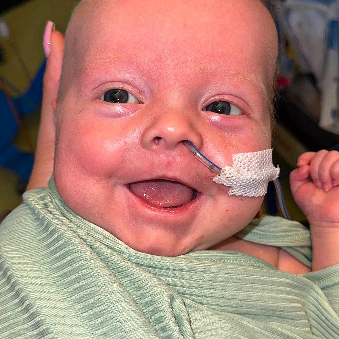 Layne Kash is registered to the contest to win money with this photo: architecture, baby, bodypart, building, cutlery, face, finger, hand, happy, head, hospital, laughing, mouth, newborn, person, photography, portrait, smile, spoon, teeth