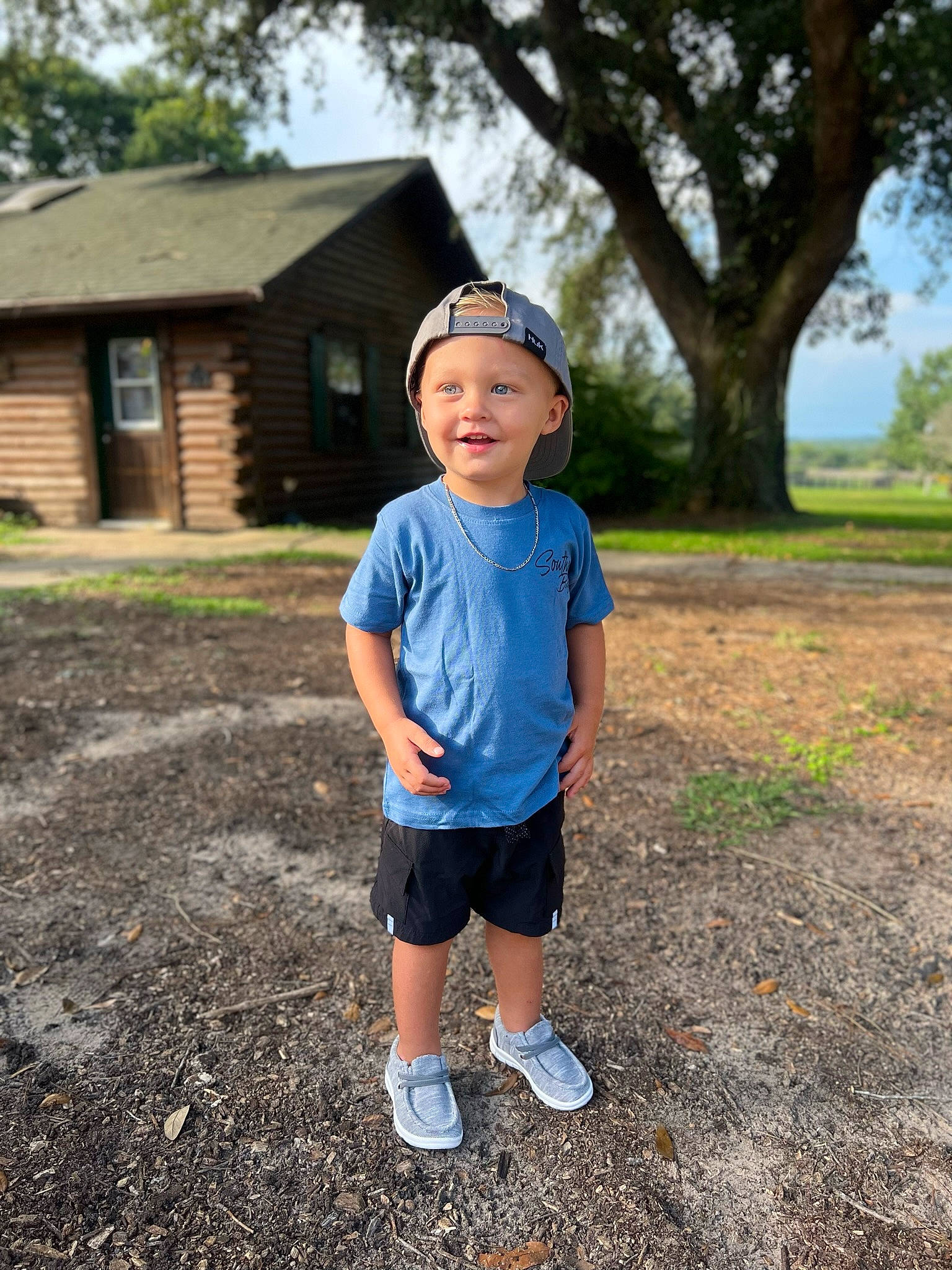 Kayden joined the competition — help win amazing prizes! asphalt, eye, grass, grassland, happy, hat, headwear, house, joy, landscape, leaf, leisure, people_in_nature, person, plant, shorts, sky, sleeve, sneakers, summer