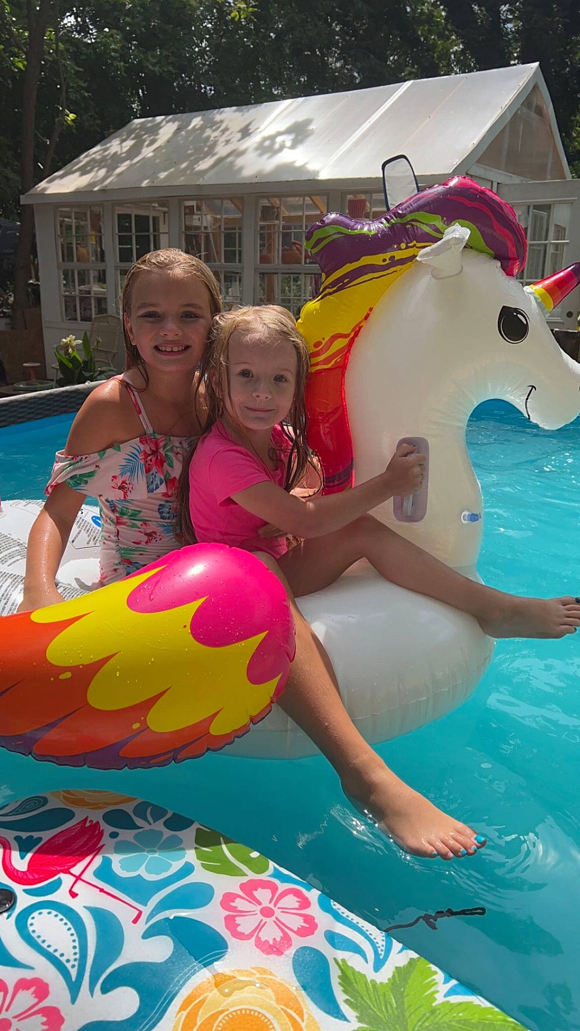 Serenity is registered to the contest to win money with this photo: baby_float, blue, child, event, fun, green, happy, horse, joy, leisure, outdoor_recreation, person, personal_protective_equipment, pink, recreation, shorts, smile, swimming_pool, swimwear, toddler