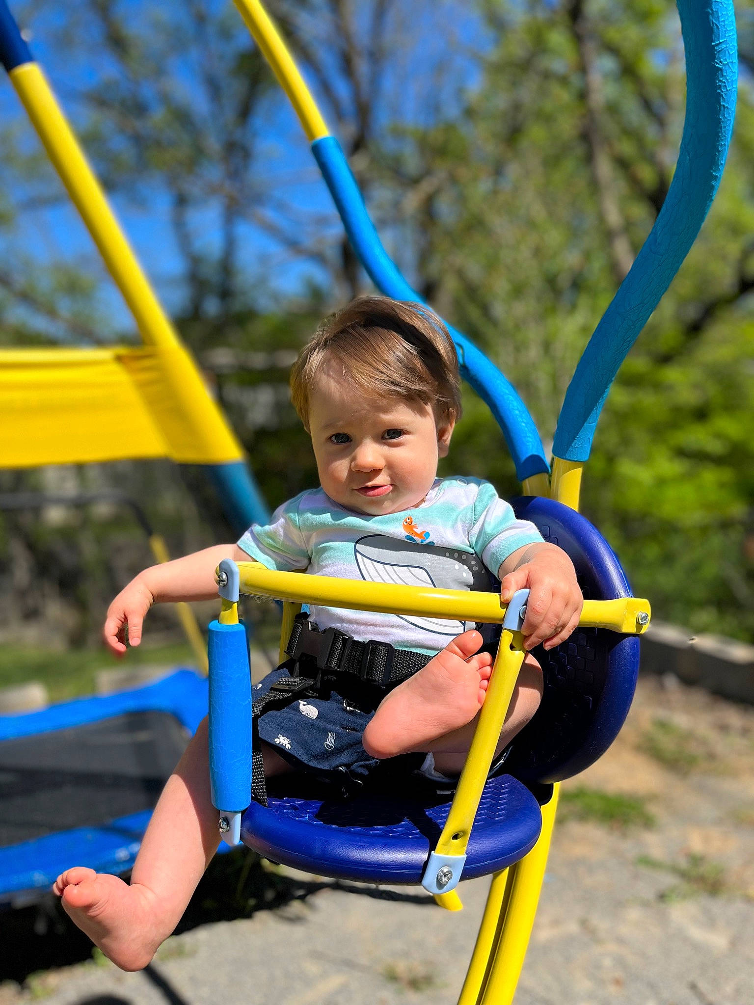 Spencer is registered to the contest to win money with this photo: baby, electric_blue, fun, grass, happy, human_body, leisure, nature, person, plant, playground, public_space, recreation, shorts, sky, smile, summer, swing, toddler, tree