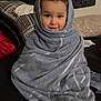 baby, blanket, clothing, couch, face, fashion, furniture, happy, hat, head, hood, hoodie, knitwear, person, photography, portrait, smile, sweater, sweatshirt, towel