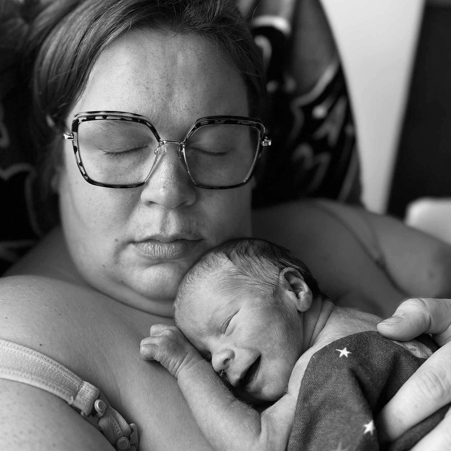 Everett joined the competition — help win amazing prizes! newborn, baby, infant, adult, parent, sleeping, cuddling, portrait, black_and_white, monochrome, glasses, eyeglasses, blanket, star_pattern, close_up, indoors, family, tender, resting, photography