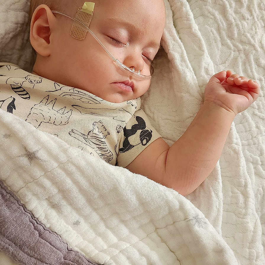 Levi joined the competition — help win amazing prizes! baby, bandage, bed, blanket, child, clothing, comfort, cute, face, hand, healthcare, indoors, infant, nasal_cannula, peaceful, portrait, rest, skin, sleeping, soft