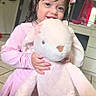 child, girl, pink_dress, stuffed_animal, plush_bunny, indoors, wet_hair, hair_bows, smiling, happy, toy, floor_tiles, dresser, home, person, cute, childhood, playful, young, toddler