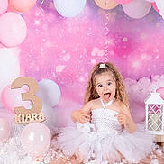 Kiara participe au concours pour gagner de l'argent avec cette photo : child, girl, birthday, balloons, pink, white, tutu, celebration, number_three, party, decorations, lantern, playful, happy, smiling, sparkles, curly_hair, background, floor, studio