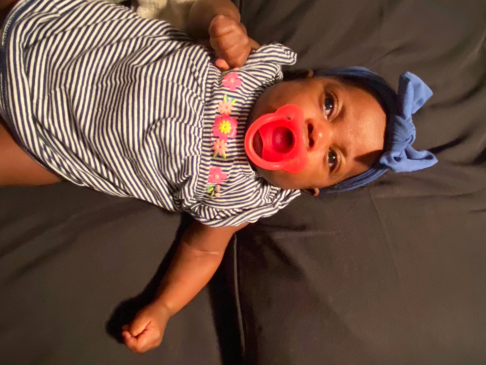 Princess is registered to the contest to win money with this photo: baby, baby_toddler_clothing, chest, child, comfort, elbow, eyelash, eyewear, glasses, hat, human_leg, joint, knee, linens, pattern, person, sleeve, sunglasses, t_shirt, thigh