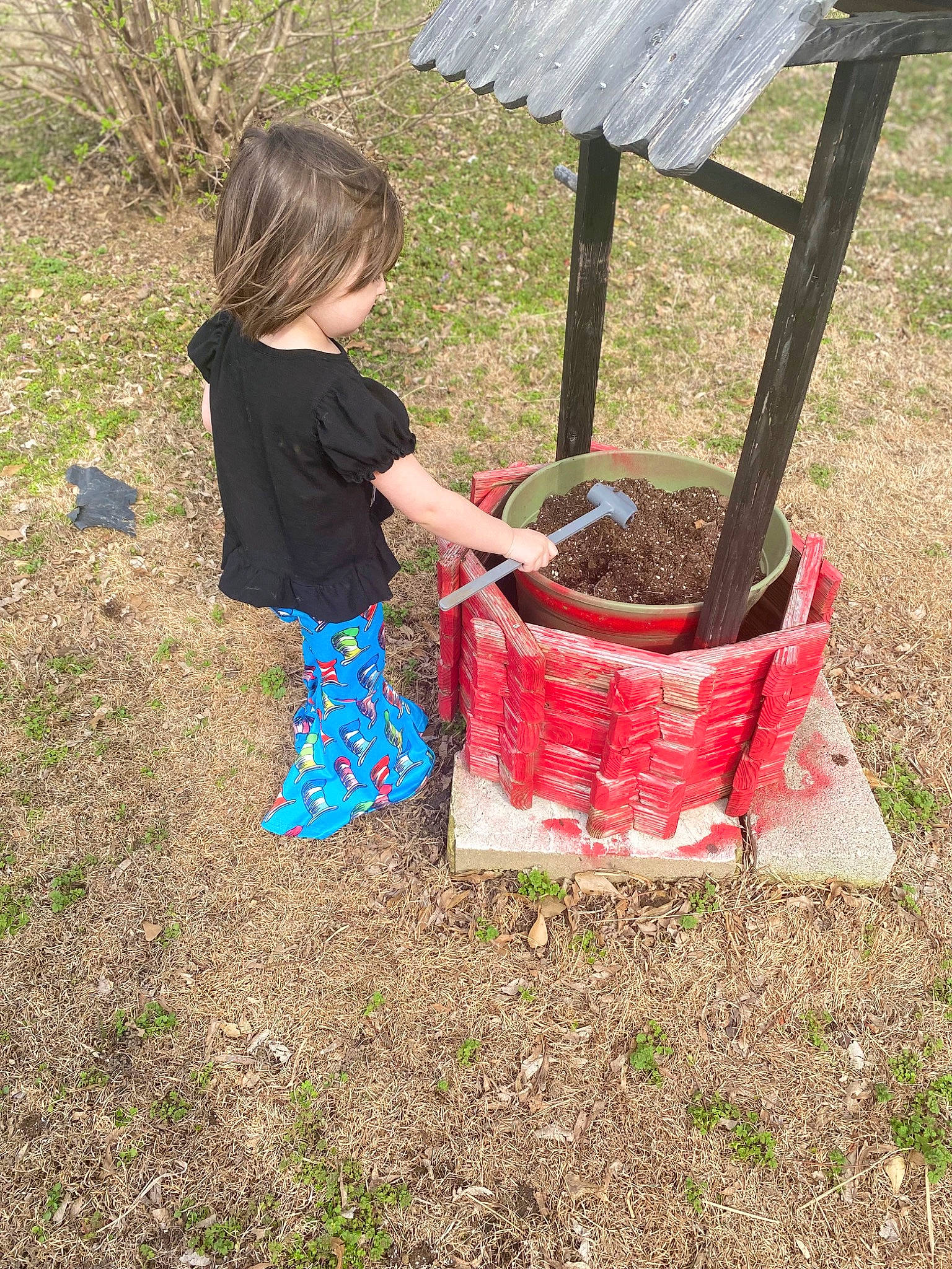 Ava is registered to the contest to win money with this photo: baby_toddler_clothing, backyard, child, fun, garden, grass, leisure, outdoor_furniture, pattern, people_in_nature, person, play, recreation, shorts, soil, t_shirt, toddler, yard