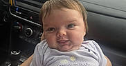 Eleanor joined the competition — help win amazing prizes! arms, baby, car_interior, child, clothing, clouds, dashboard, expression, face, hand, infant, onesie, person, portrait, road, seat, seatbelt, sky, sun, window