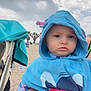 baby, beach, blue_hooded_towel, child, clothing, cloudy_sky, cute, family, holding, outdoor, palm_trees, person, pink_blanket, portrait, sand, serious_expression, stroller, summer, toddler, vacation