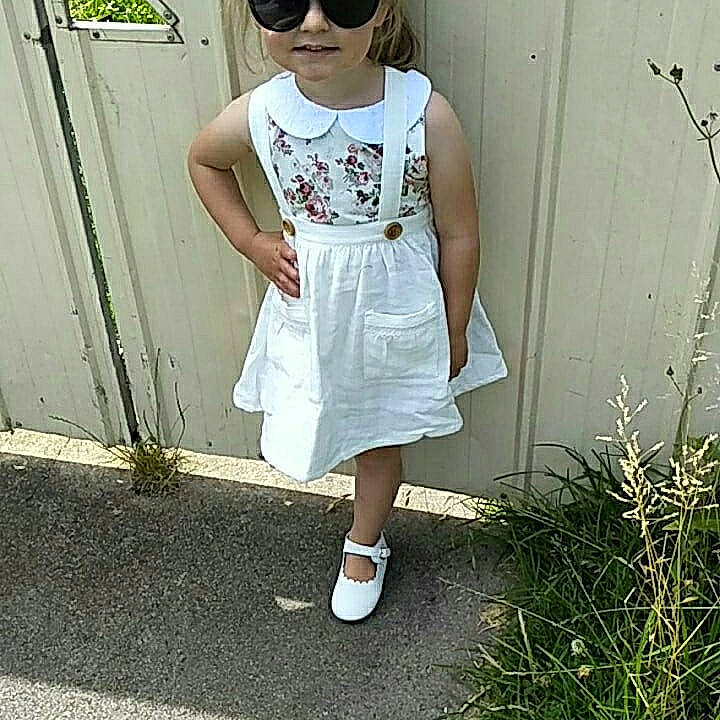 Kasey joined the competition — help win amazing prizes! baby_toddler_clothing, clothing, day_dress, dress, embellishment, goggles, headwear, one_piece_garment, pattern, person, sleeve, street_fashion, sunglasses, white