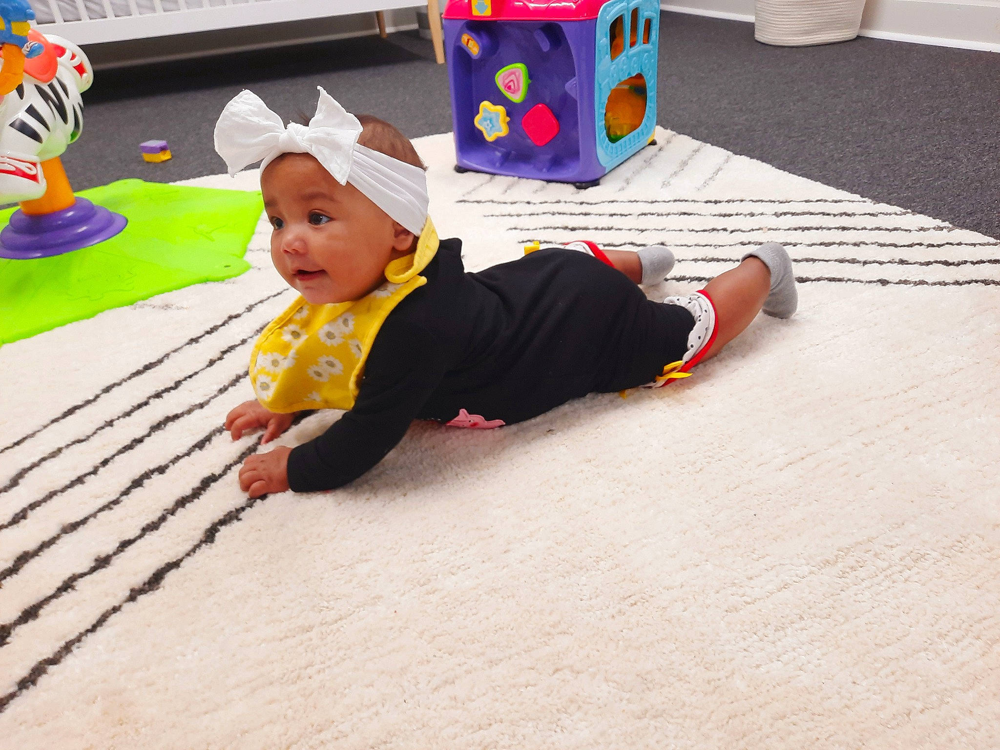 Mckayla joined the competition — help win amazing prizes! baby, baby_toddler_clothing, baby_toys, child, crawling, floor, flooring, fun, headwear, leisure, pattern, person, plastic, play, playmat, recreation, room, sitting, toddler, vacation