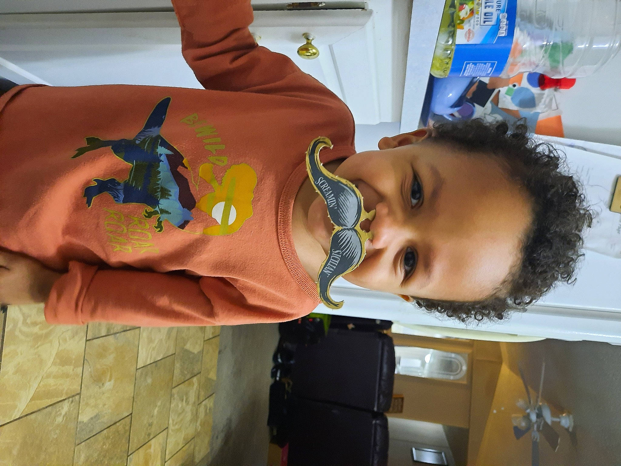 Kobe is registered to the contest to win money with this photo: baby, baby_products, baby_toddler_clothing, child, elbow, finger, fun, gesture, happy, mouth, person, room, sleeve, t_shirt, thumb, toddler, vacation, visual_arts, wrist