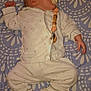 baby, sleeping, pacifier, pajamas, slippers, blanket, infant, child, cute, cozy, pattern, lying_down, indoors, peaceful, soft_lighting, clothing, person, bedtime, resting, cute_outfit