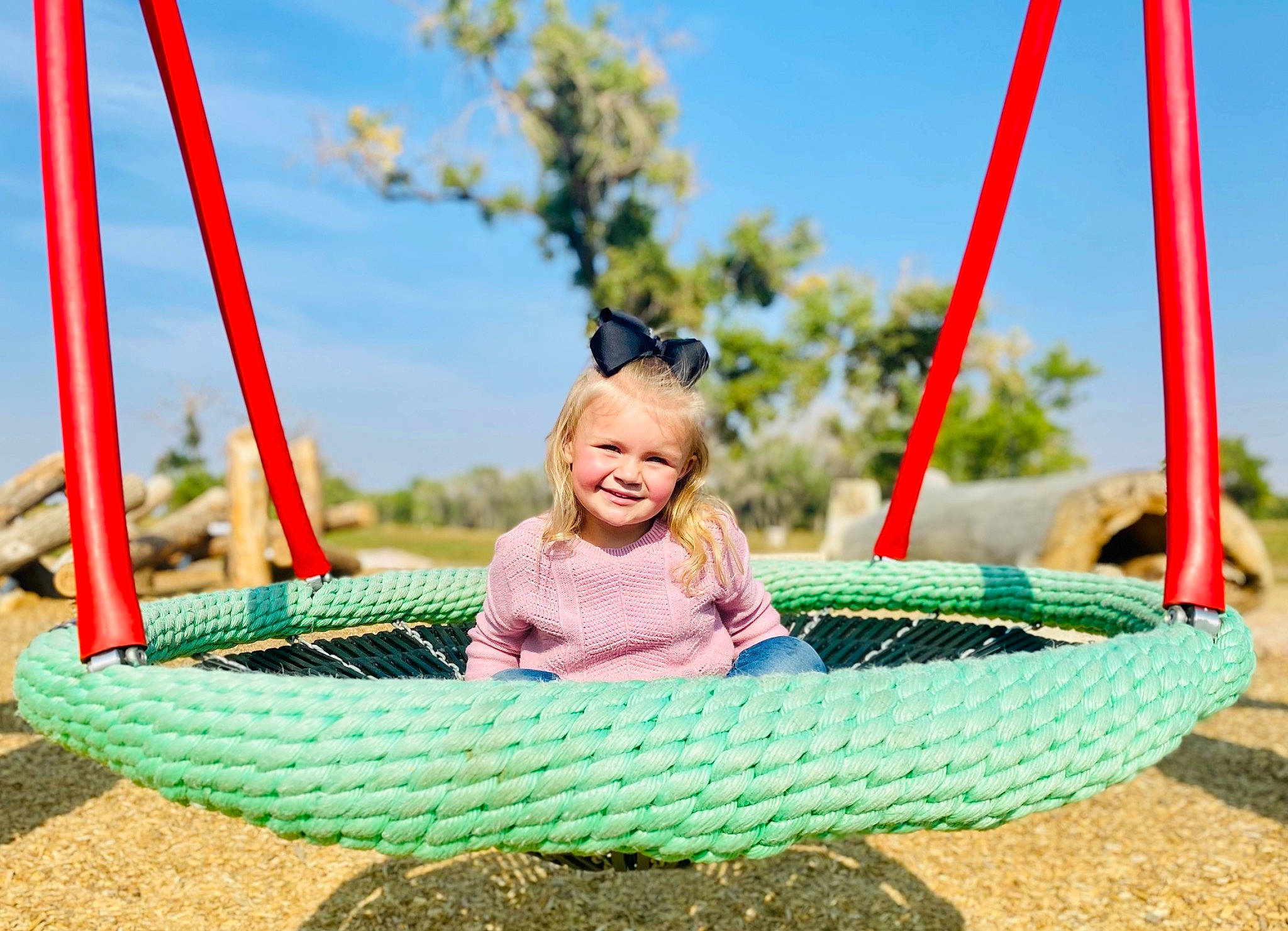 Myaleigh is registered to the contest to win money with this photo: basket, blue, city, fun, grass, green, happy, joy, leisure, outdoor_play_equipment, outdoor_recreation, people_in_nature, person, plant, recreation, sky, smile, sunglasses, swing, tire