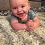baby, smiling, happy, infant, rug, carpet, living_room, couch, child, cute, skin, hands, clothing, indoors, portrait, human, baby_clothes, closeup, playful, young_child