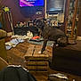 dog, brindle, ottoman, wooden_crate, living_room, clutter, clothes, shoes, television, family_photos, shelf, window_blinds, floor, furniture, decorations, household_items, crate, pet, indoor, curious