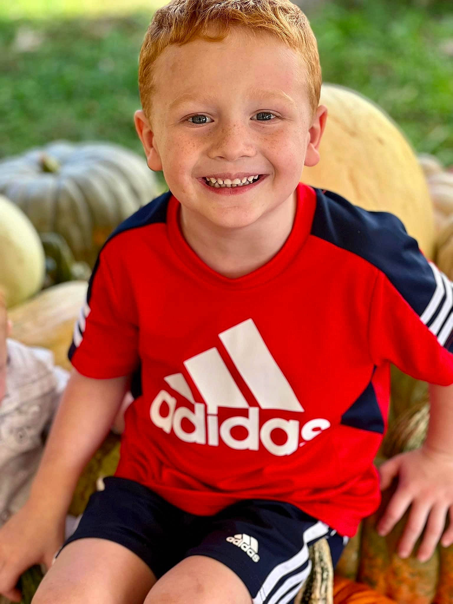 Kaedyn Andrew joined the competition — help win amazing prizes! child, chin, facial_expression, fun, grass, happy, human, human_leg, joy, leisure, orange, people_in_nature, person, recreation, skin, sleeve, smile, sportswear, t_shirt, thigh