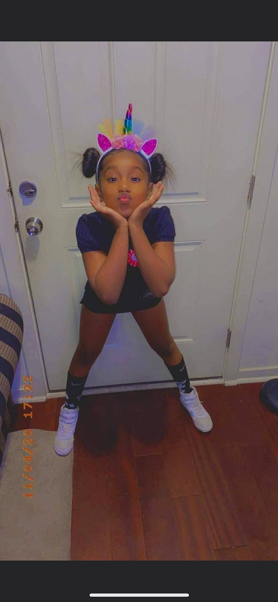 Chasity is registered to the contest to win money with this photo: abdomen, balance, calf, chest, floor, flooring, hardwood, hat, human_leg, knee, leg, performing_arts, person, shoe, shorts, sports_gear, sportswear, sweatpant, thigh, trunk