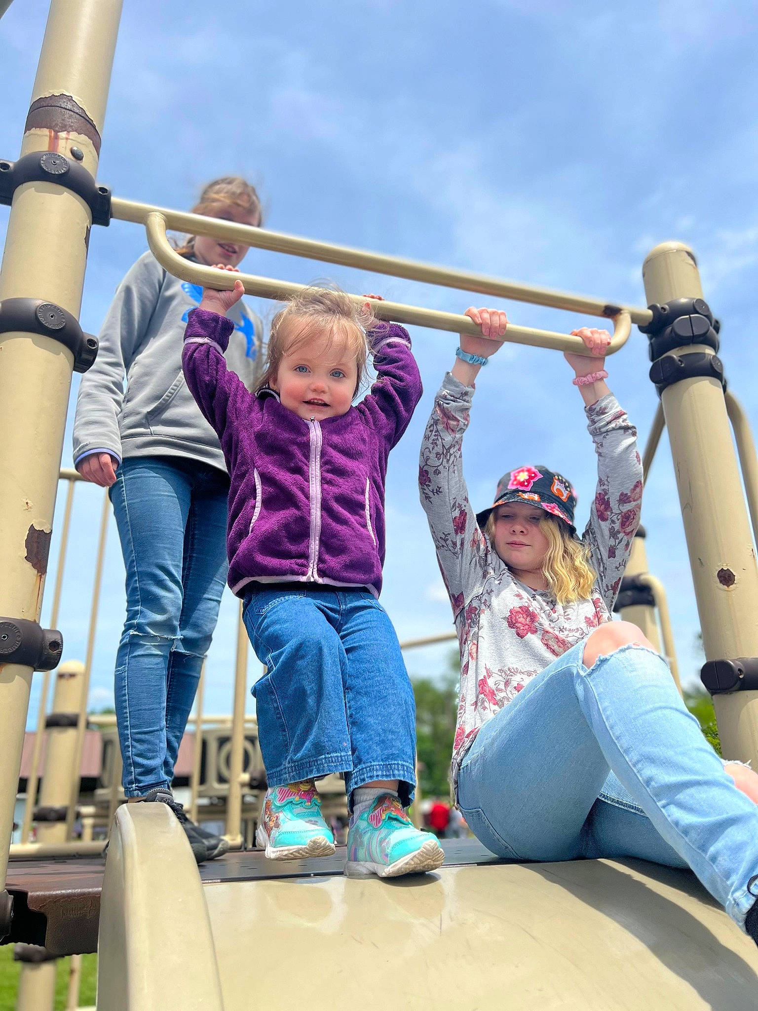 Marilyn is registered to the contest to win money with this photo: amusement_park, child, chute, city, cloud, fun, happy, headwear, jeans, joy, leisure, outdoor_play_equipment, person, playground, pole, recreation, rope, shorts, sky, smile