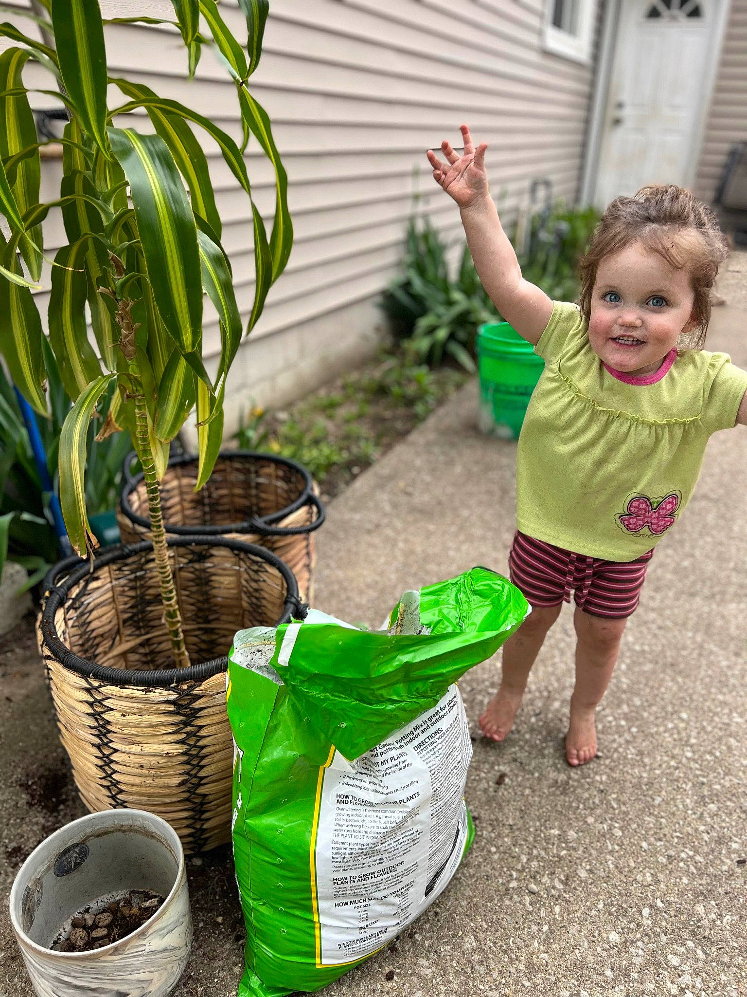 Marilyn joined the competition — help win amazing prizes! baby_toddler_clothing, botany, event, garden, grass, green, happy, herb, houseplant, joy, leisure, people_in_nature, person, plant, plastic_bag, sandal, shorts, smile, soil, t_shirt