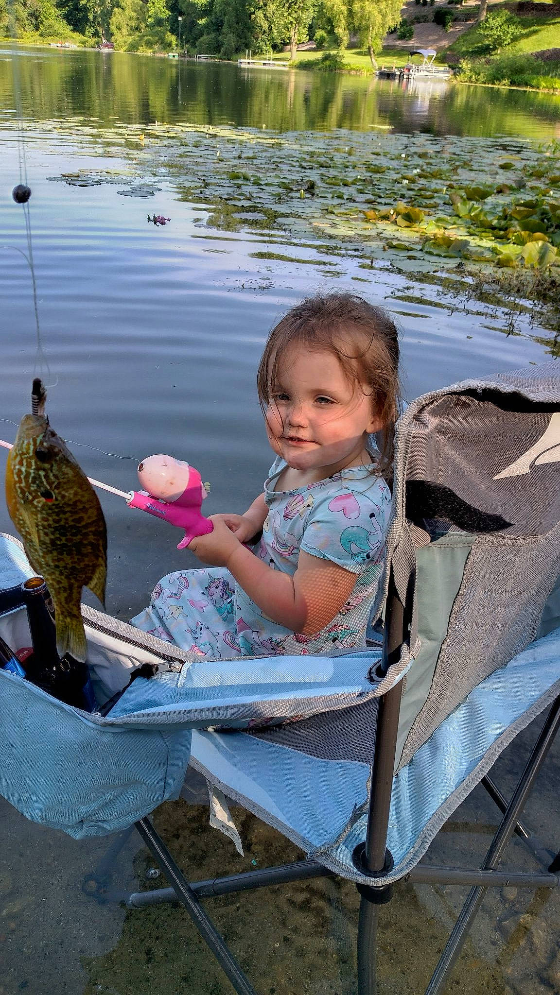 Marilyn joined the competition — help win amazing prizes! baby, boats_and_boating_equipment_and_supplies, body_of_water, chair, child, fish, fun, grass, happy, lake, leisure, outdoor_furniture, people_in_nature, person, plant, recreation, sitting, snapshot, toddler, travel