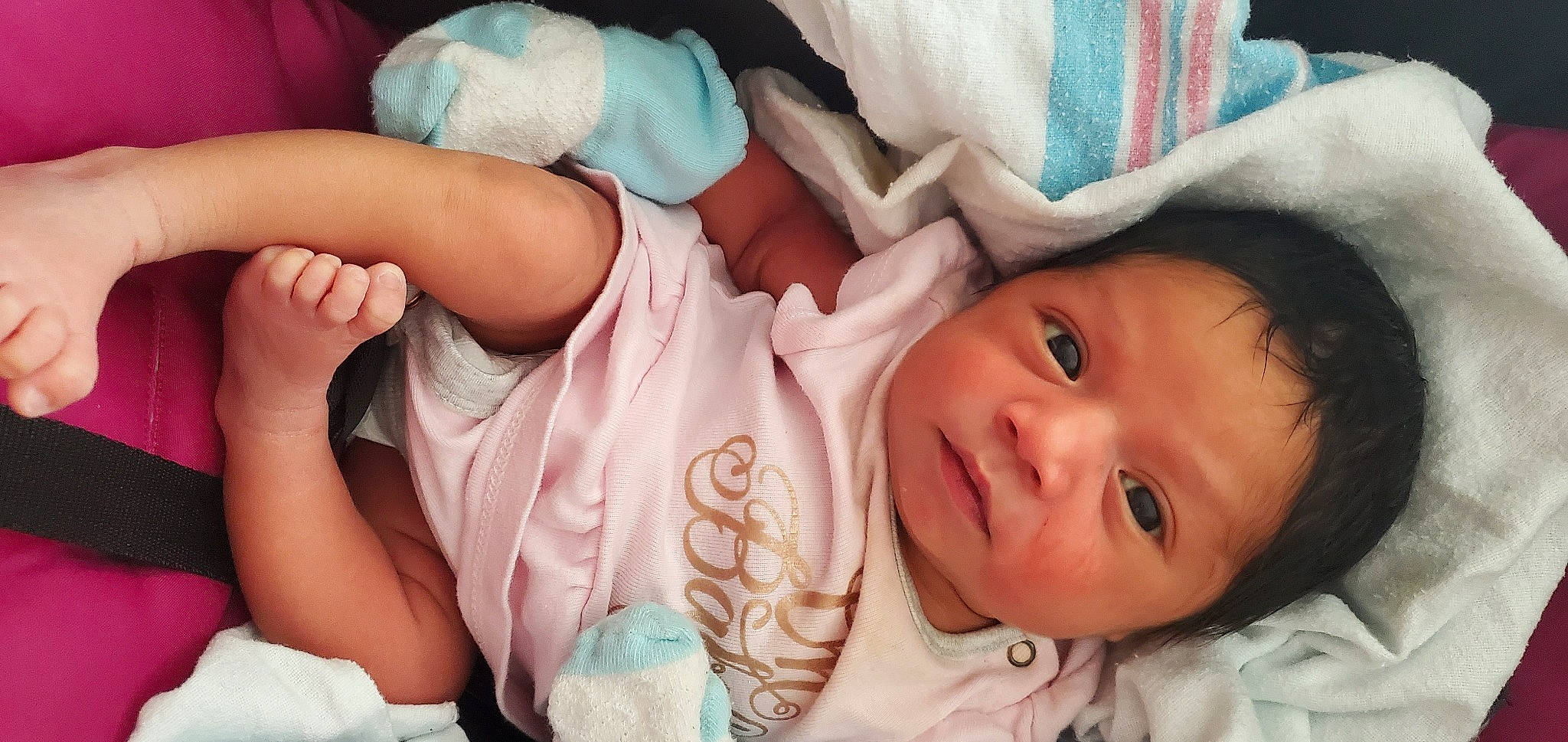 Ava is registered to the contest to win money with this photo: arm, baby, baby_toddler_clothing, cheek, comfort, eye, eyelash, facial_expression, gesture, human, human_body, lip, mouth, nose, organ, person, pink, product, skin, smile