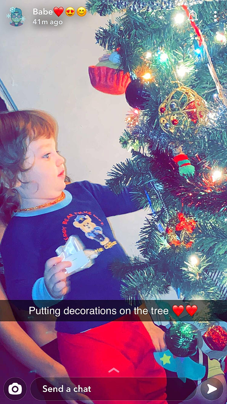 Zander is registered to the contest to win money with this photo: branch, child, christmas, christmas_decoration, christmas_eve, christmas_lights, christmas_ornament, christmas_tree, conifer, fir, interior_design, person, pine_family, plant, play, smile, toddler, tree