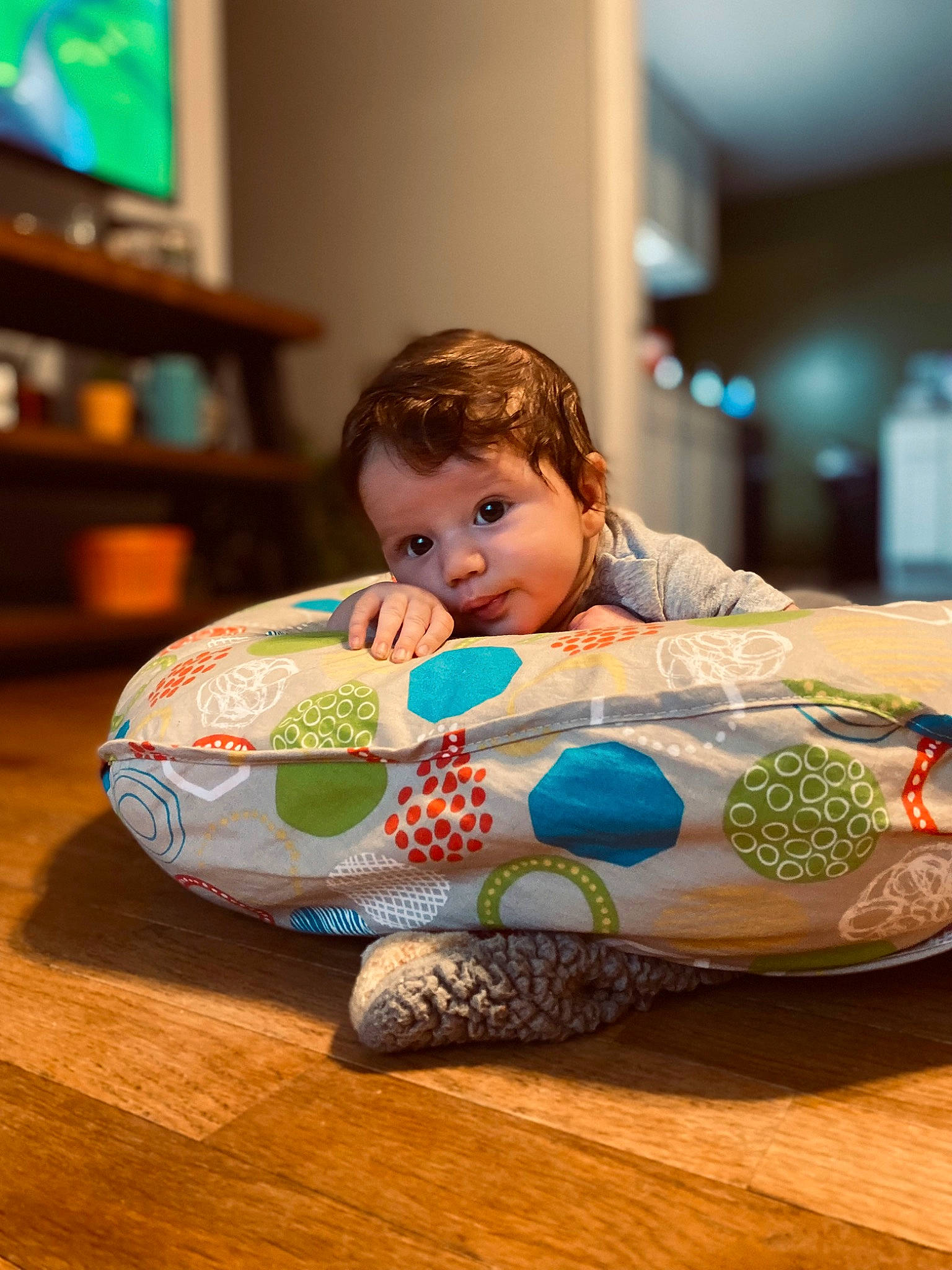 Brooks is registered to the contest to win money with this photo: baby, baby_toddler_clothing, child, comfort, display_device, flooring, fun, happy, hardwood, leisure, living_room, person, plate, porcelain, room, sitting, sweetness, tableware, television, toddler