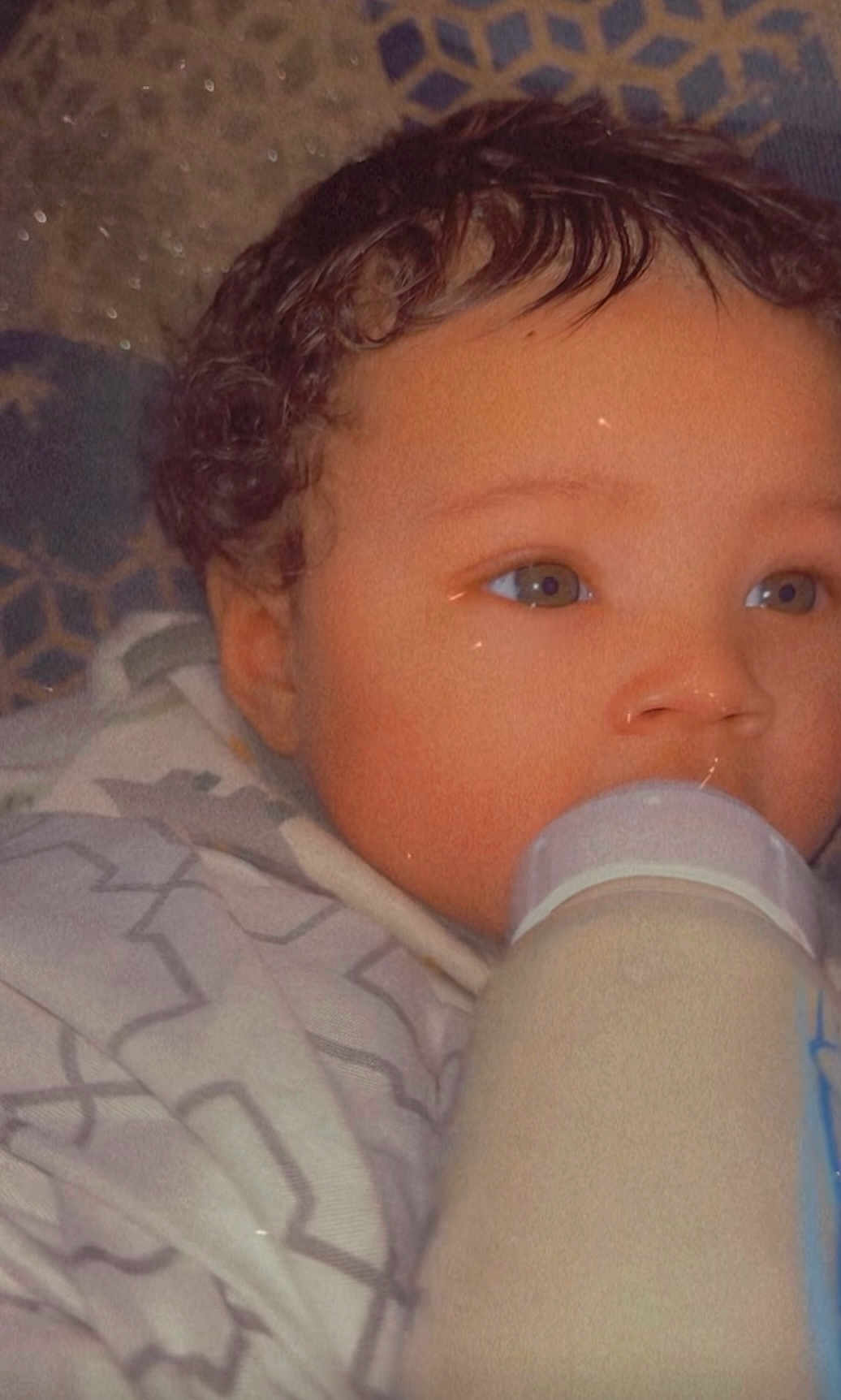 Vontray joined the competition — help win amazing prizes! baby, blanket, bottle, child, close_up, comfort, curly_hair, cute, expression, face, feeding, indoors, infant, peaceful, portrait, sleepy, soft_lighting, warm_colors, wrapped, young_child