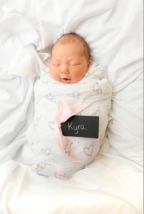 Kyra is registered to the contest to win money with this photo: baby, baby_products, baby_sleeping, baby_toddler_clothing, bedding, bedtime, cheek, child, comfort, fashion_accessory, font, happy, linens, pattern, person, portrait_photography, room, sitting, sleep, sleeve