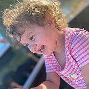 Nevalynn joined the competition — help win amazing prizes! child, toddler, curly_hair, smile, candid, outdoors, sunlight, pink_checkered_shirt, lemon_patch, hand, toy, green_bubble_container, dirt_on_face, teeth, profile, portrait, happy, playful, summer, closeup