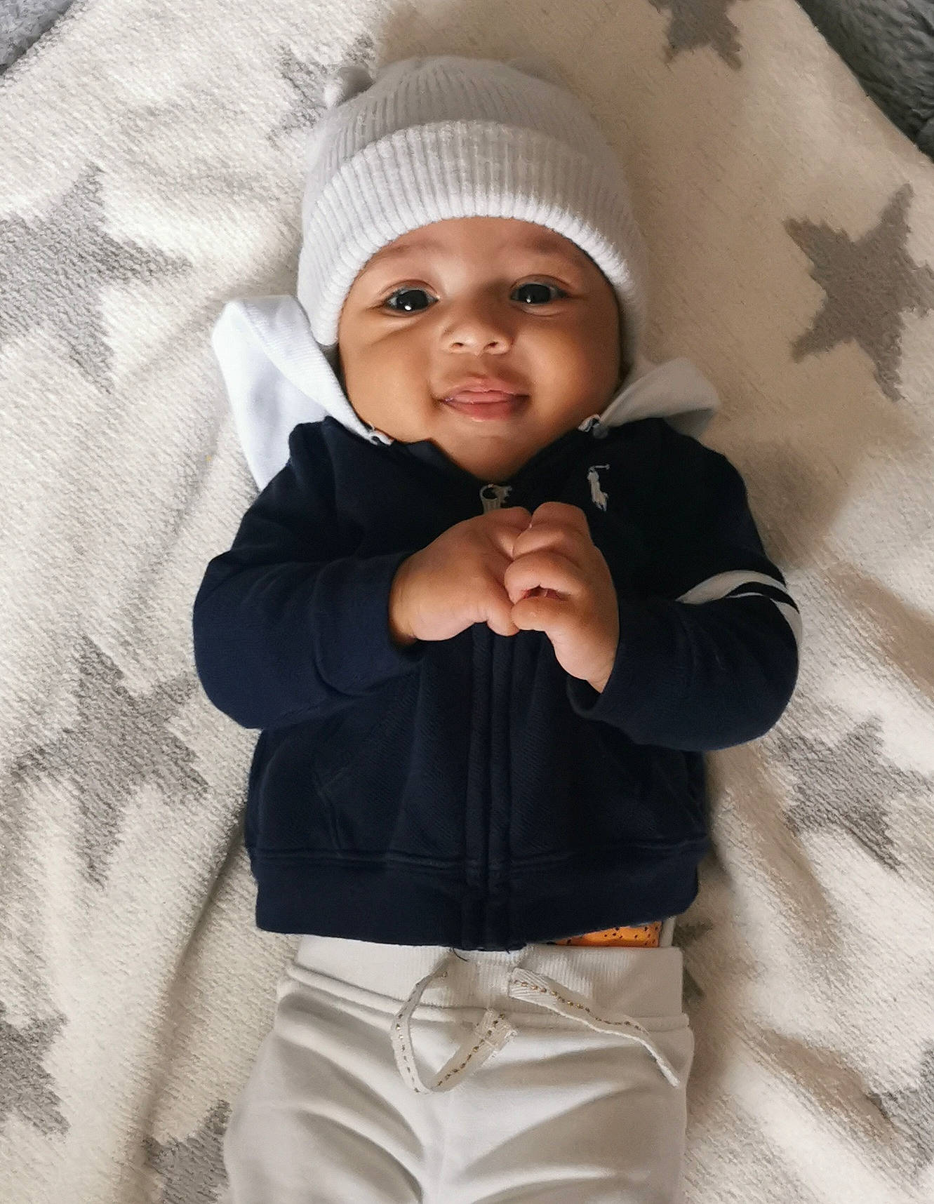 Izayah joined the competition — help win amazing prizes! baby, baby_toddler_clothing, cap, child, clothing, collar, comfort, cool, dress_shirt, face, facial_expression, gesture, happy, headwear, knit_cap, outerwear, person, skin, sleeve, smile