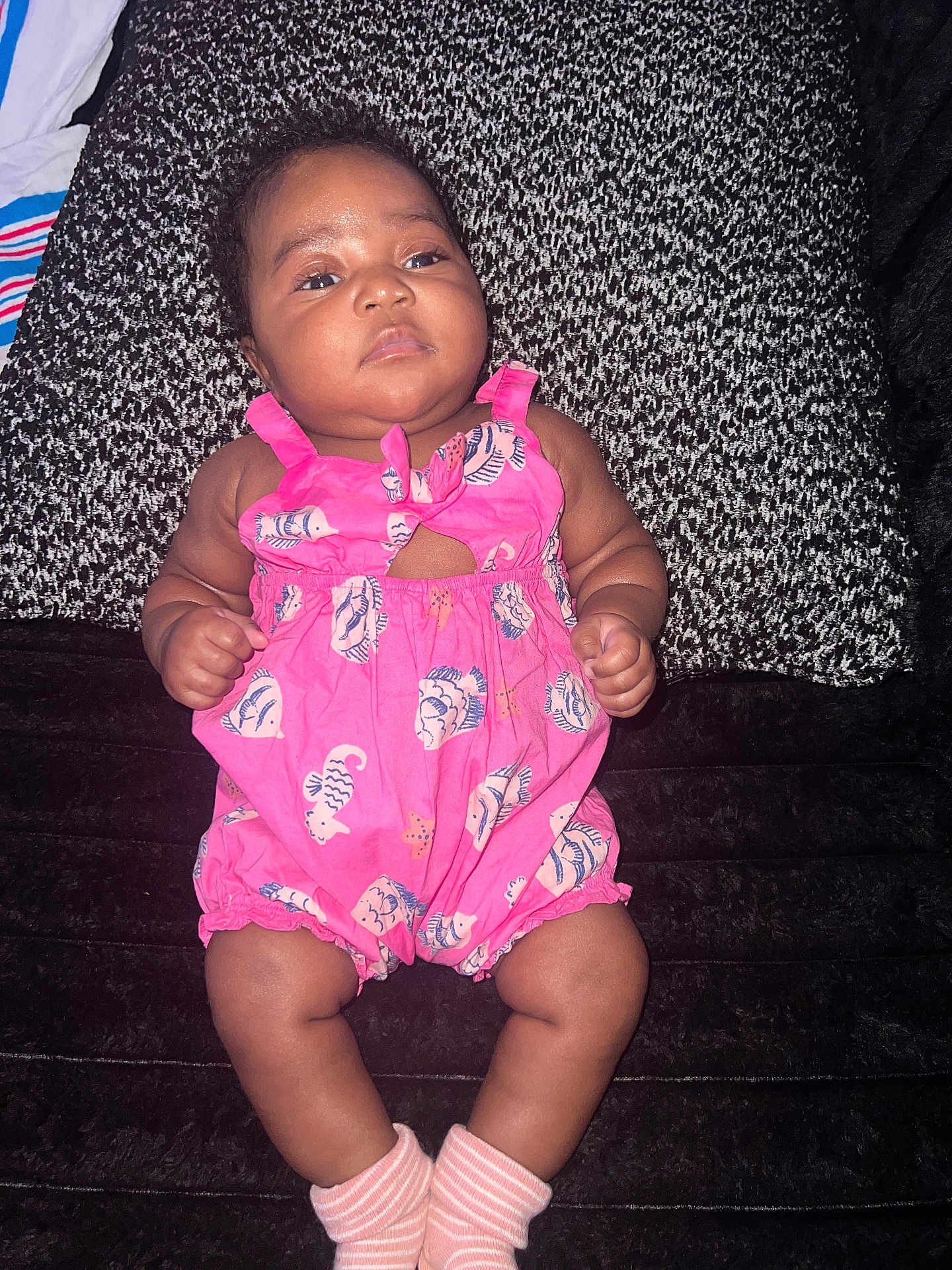 Jayda joined the competition — help win amazing prizes! baby, infant, pink_romper, fish_pattern, socks, cushion, black_and_white, texture, cute, child, lying_down, skin, face, arms, legs, indoors, portrait, newborn, soft, clothing