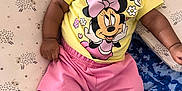 Jayda joined the competition — help win amazing prizes! baby, child, infant, mickey_mouse, minnie_mouse, yellow_shirt, pink_shorts, white_socks, pillow, blanket, pattern, cute, smiling, indoor, soft_toys, clothing, face, person, relaxing, lying_down