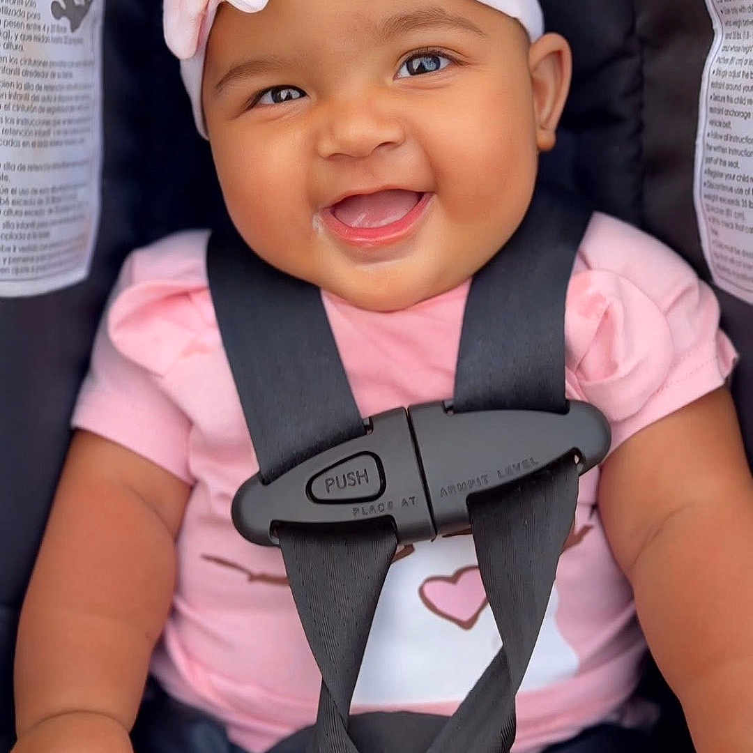 Salah joined the competition — help win amazing prizes! adorable, baby, baby_girl, car_seat, child, chubby_cheeks, closeup, cute, happy, headband, indoor, infant, person, pink_clothing, portrait, safety_harness, seat, seatbelt, smiling, toddler