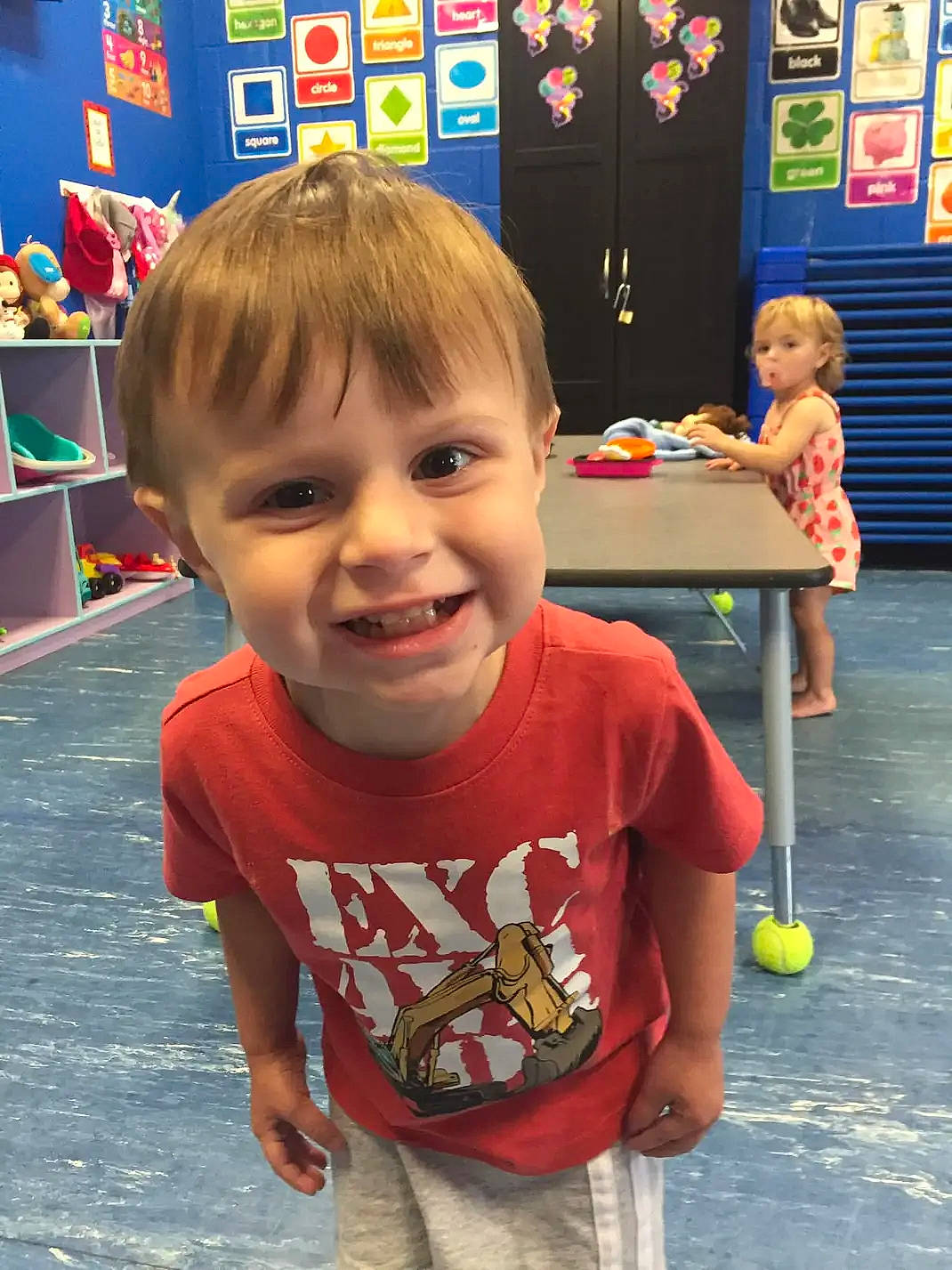 Bennett Reece is registered to the contest to win money with this photo: baby, child, event, flooring, fun, games, happy, indoor_games_and_sports, joy, kindergarten, leisure, person, play, recreation, room, smile, standing, summer, t_shirt, table