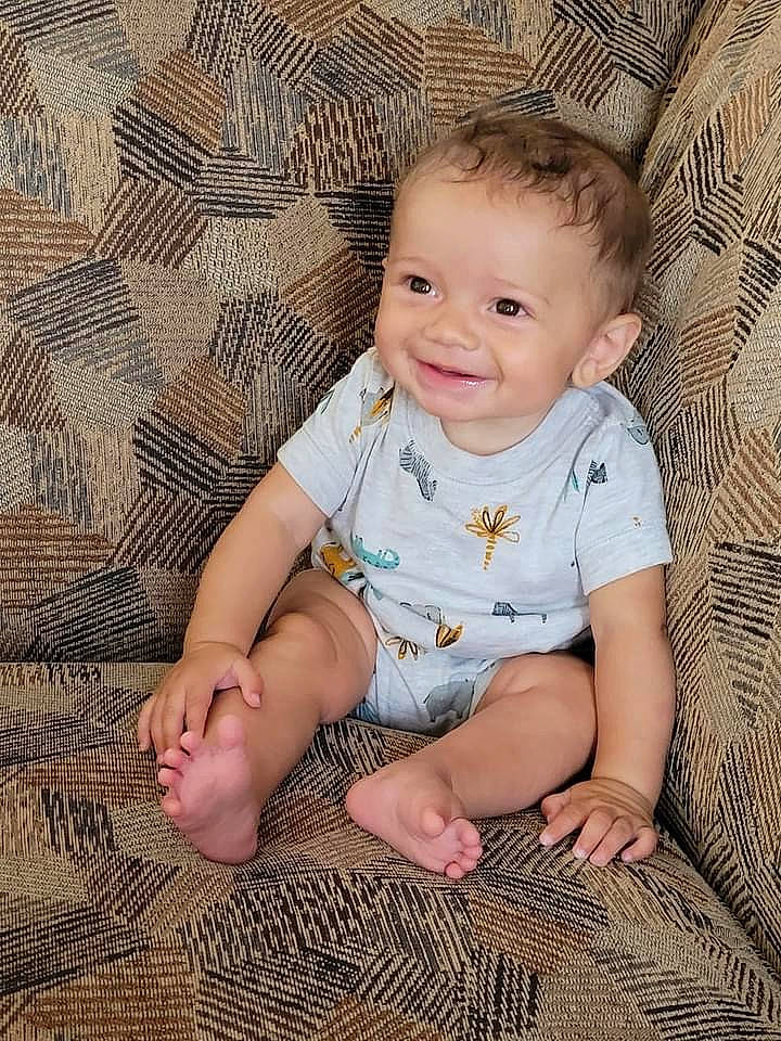 Elijah is registered to the contest to win money with this photo: baby_toddler_clothing, cheek, chin, dress, eye, face, finger, flash_photography, happy, head, iris, joy, leg, lip, nose, person, skin, sleeve, smile, standing
