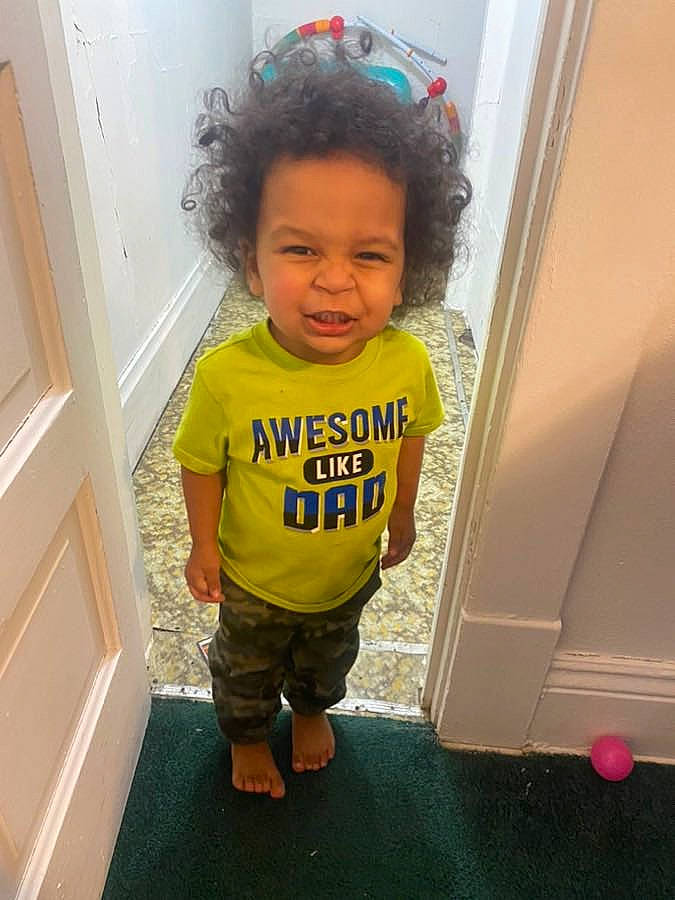 Joey is registered to the contest to win money with this photo: baby, baby_toddler_clothing, child, door, floor, flooring, fun, hair, hairstyle, happy, hardwood, head, knee, magenta, person, room, shorts, skin, sleeve, t_shirt